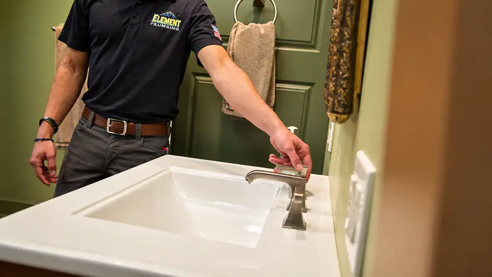 Element plumber testing a bathroom faucet