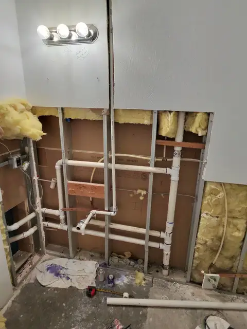 Open bathroom wall during the plumbing rough-in for a remodel