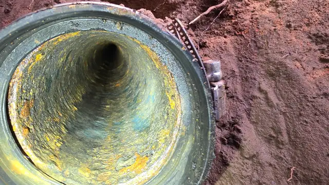 Inside a cast iron sewer line during descaling