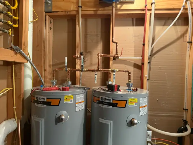 Two commercial water heaters installed side by side