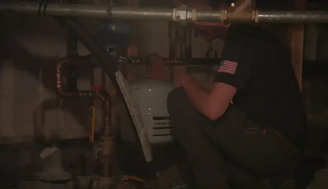 Copper and galvanized water lines being worked on in a crawl space