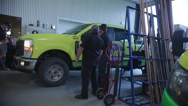Element crew loading a service truck in the shop