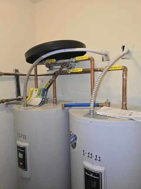 Two new water heaters with fresh plumbing connections