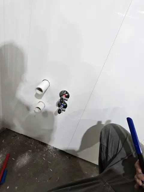 New drain and supply stub-outs ready for a fixture on a finished wall