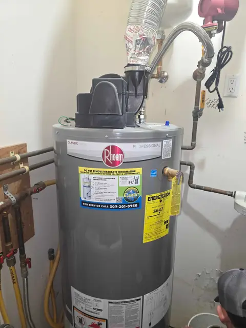 Technician servicing the venting on a gas water heater