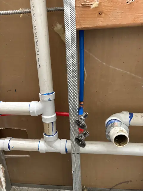 PVC drain and vent piping with new supply lines in an open wall