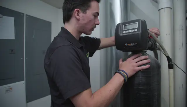 Element technician programming an iron filter control valve