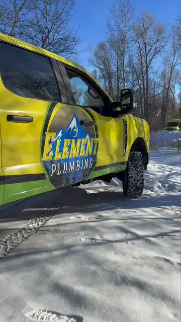 Element Plumbing truck in deep snow on a winter emergency call