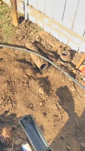 Trench dug to expose a sewer line for replacement
