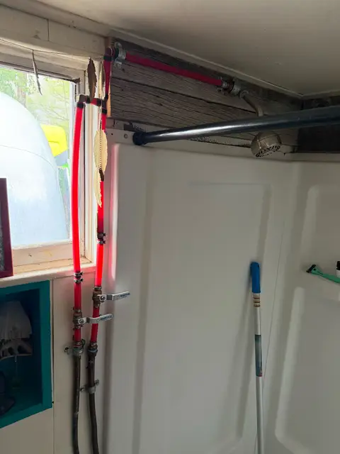 Shower water lines being repiped behind an open wall