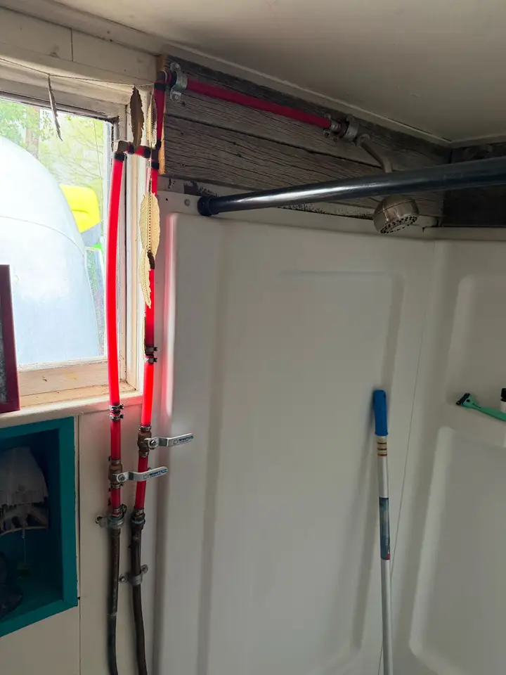 Shower water lines being repiped behind an open wall