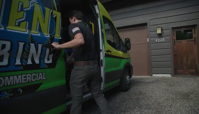 Element plumber taking tools from the service van at a client's home