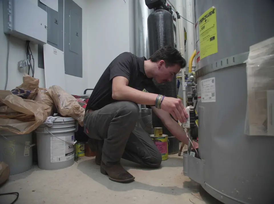 Technician servicing the controls on a water heater