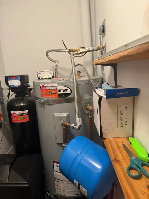 Water heater with an expansion tank and a water softener in a utility closet