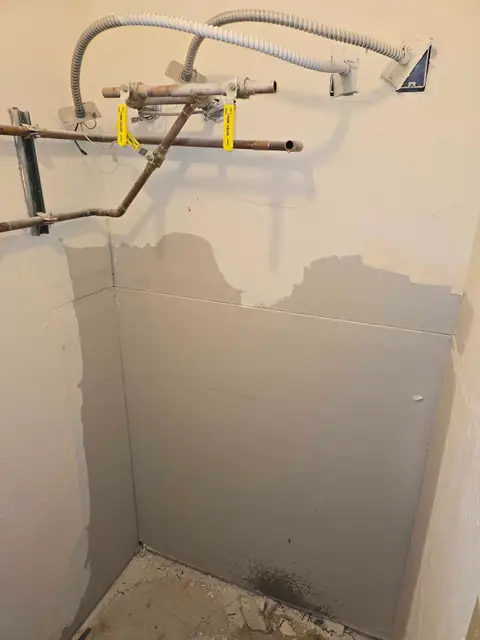 Wall opened and lines prepped for a water heater replacement