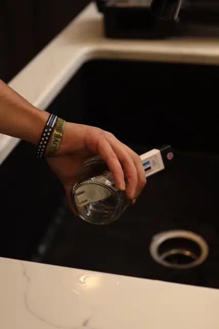 Testing a glass of tap water for water quality