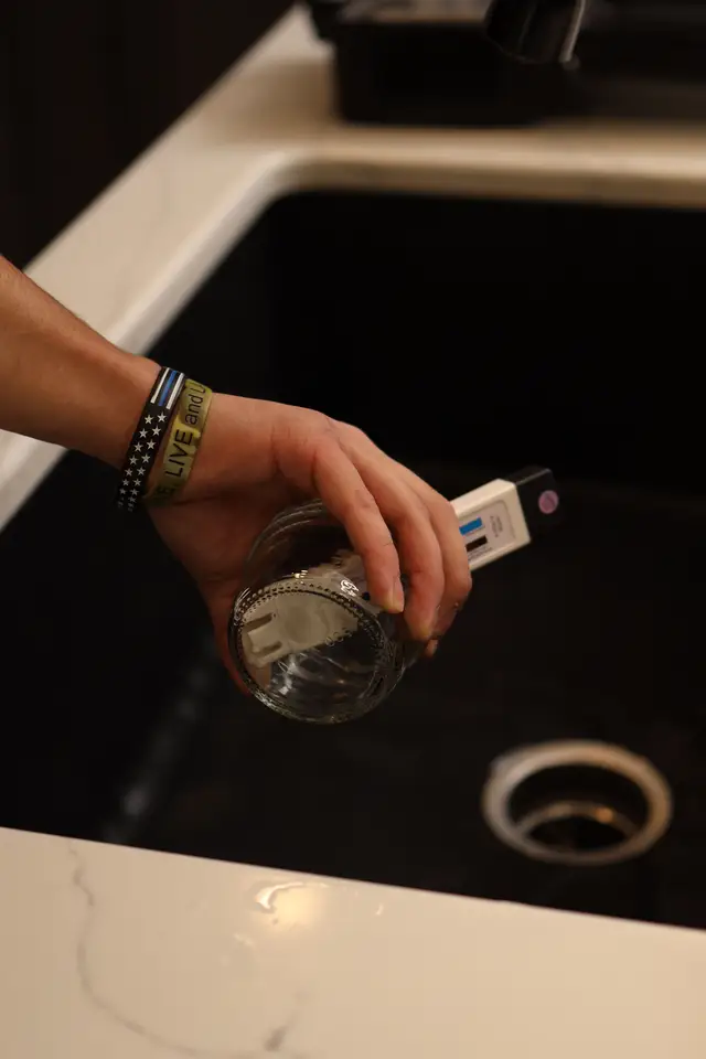 Testing a glass of tap water for water quality